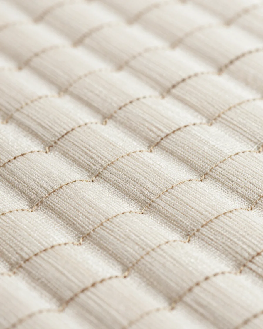 Sharp macro close-up of woven polypropylene texture and reinforced stitching, in clean industrial daylight, high contras